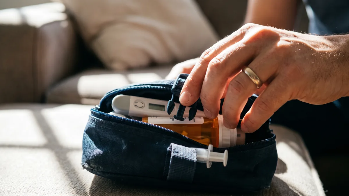 Parent checking toddler’s temperature with digital thermometer